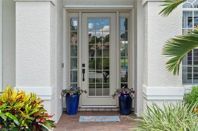 a front view of a house with a potted plant