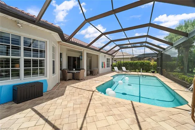 a view of a backyard with a patio and a yard