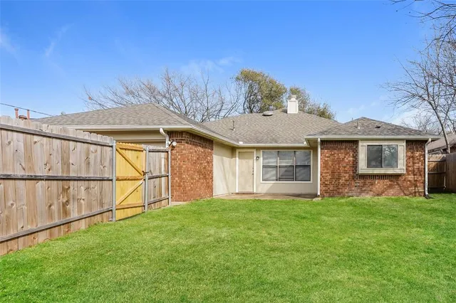 a view of a house with a yard and sitting area