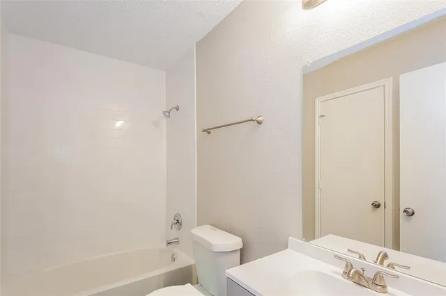 a bathroom with a bathtub and sink