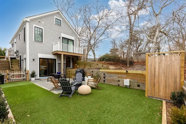 a view of a house with backyard porch and sitting area