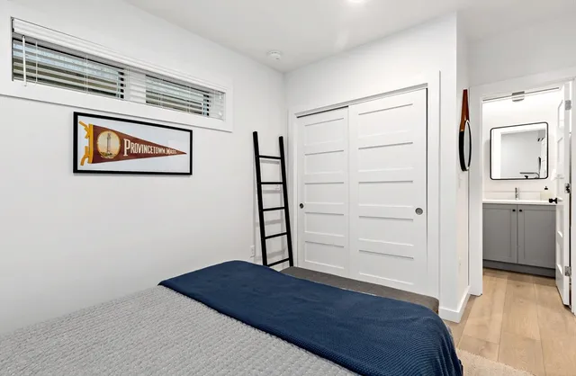 a bedroom with a bed and wooden floor