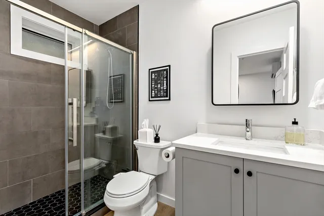 a bathroom with a toilet sink and shower