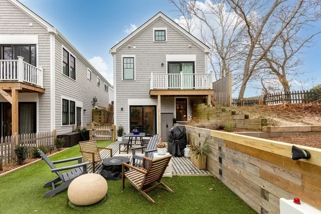a view of backyard with deck and outdoor seating