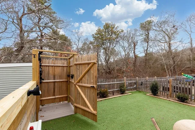 a view of a house with backyard and deck