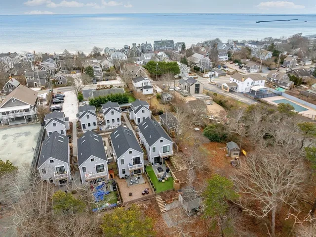 an aerial view of residential houses with outdoor space