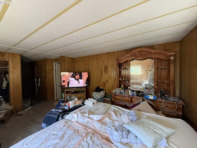 a living room with furniture a flat screen tv and a window