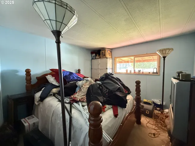 a bed sitting in a bedroom next to a window