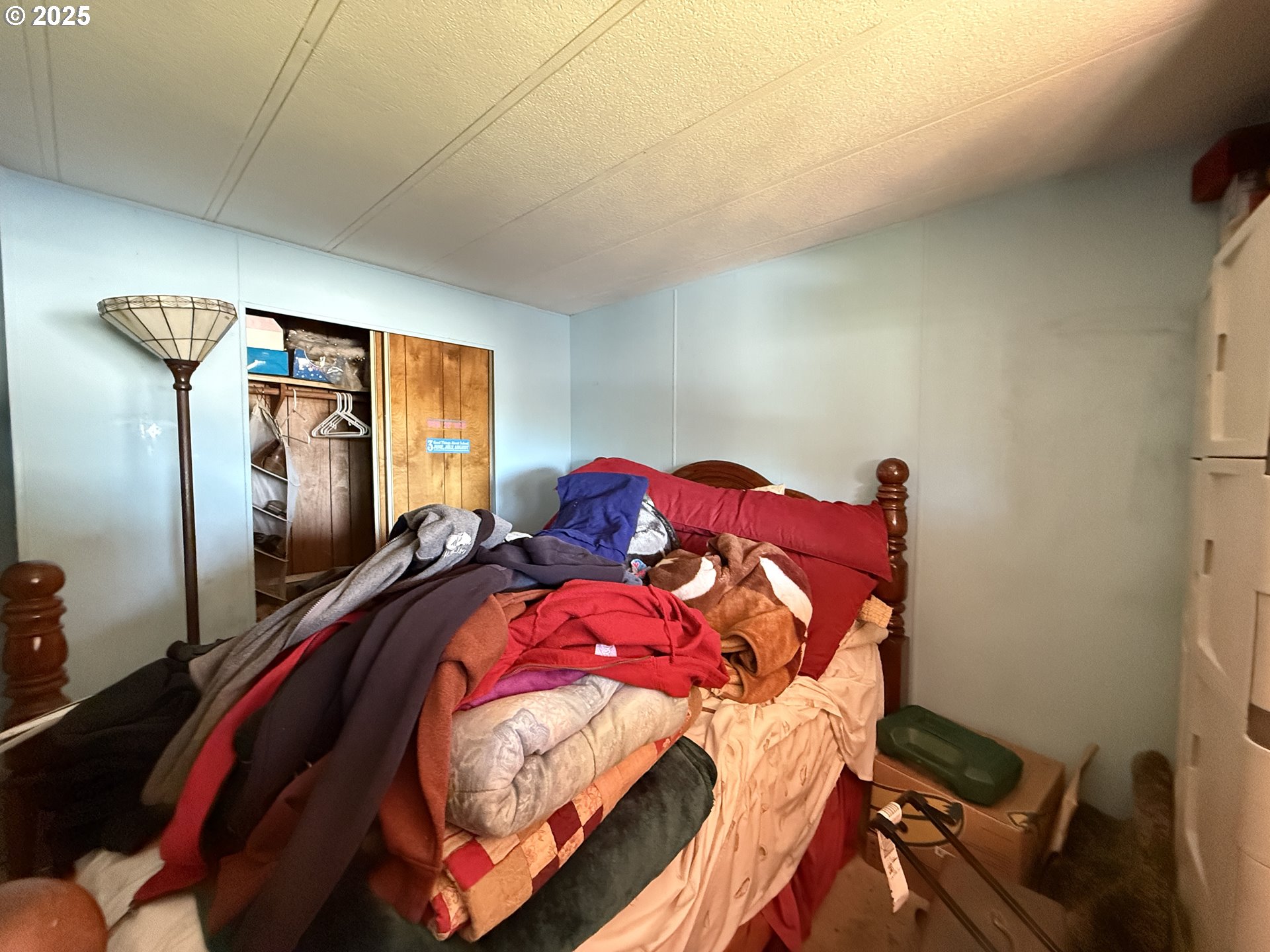 16391 Highway 101, Unit 5 Brookings, OR 97415 - Photo 19 of 27 a bed sitting in a bedroom next to a window