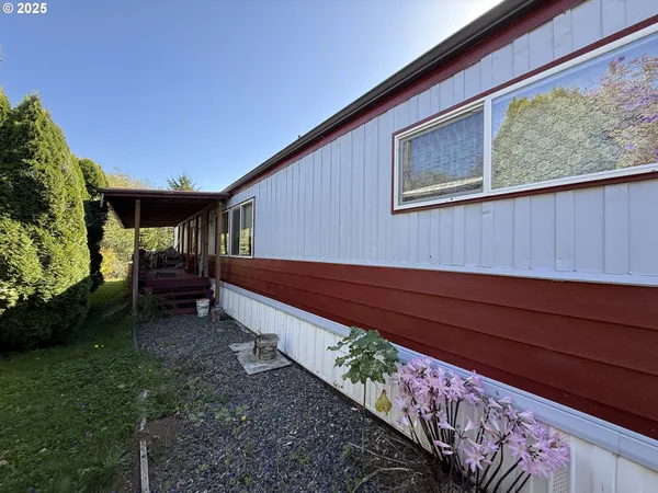 a view of backyard with deck and garden