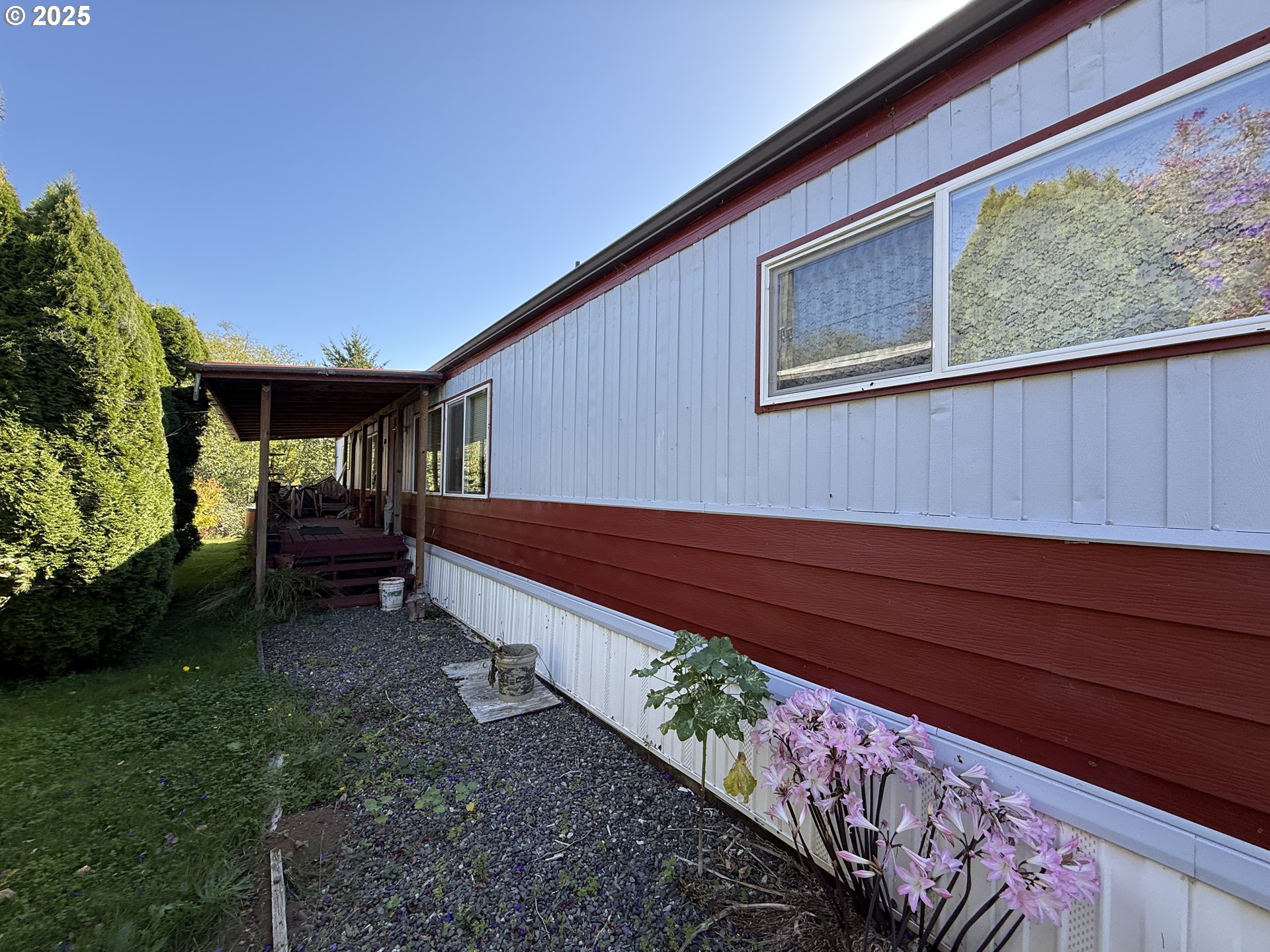 16391 Highway 101, Unit 5 Brookings, OR 97415 - Photo 8 of 27 a view of backyard with deck and garden