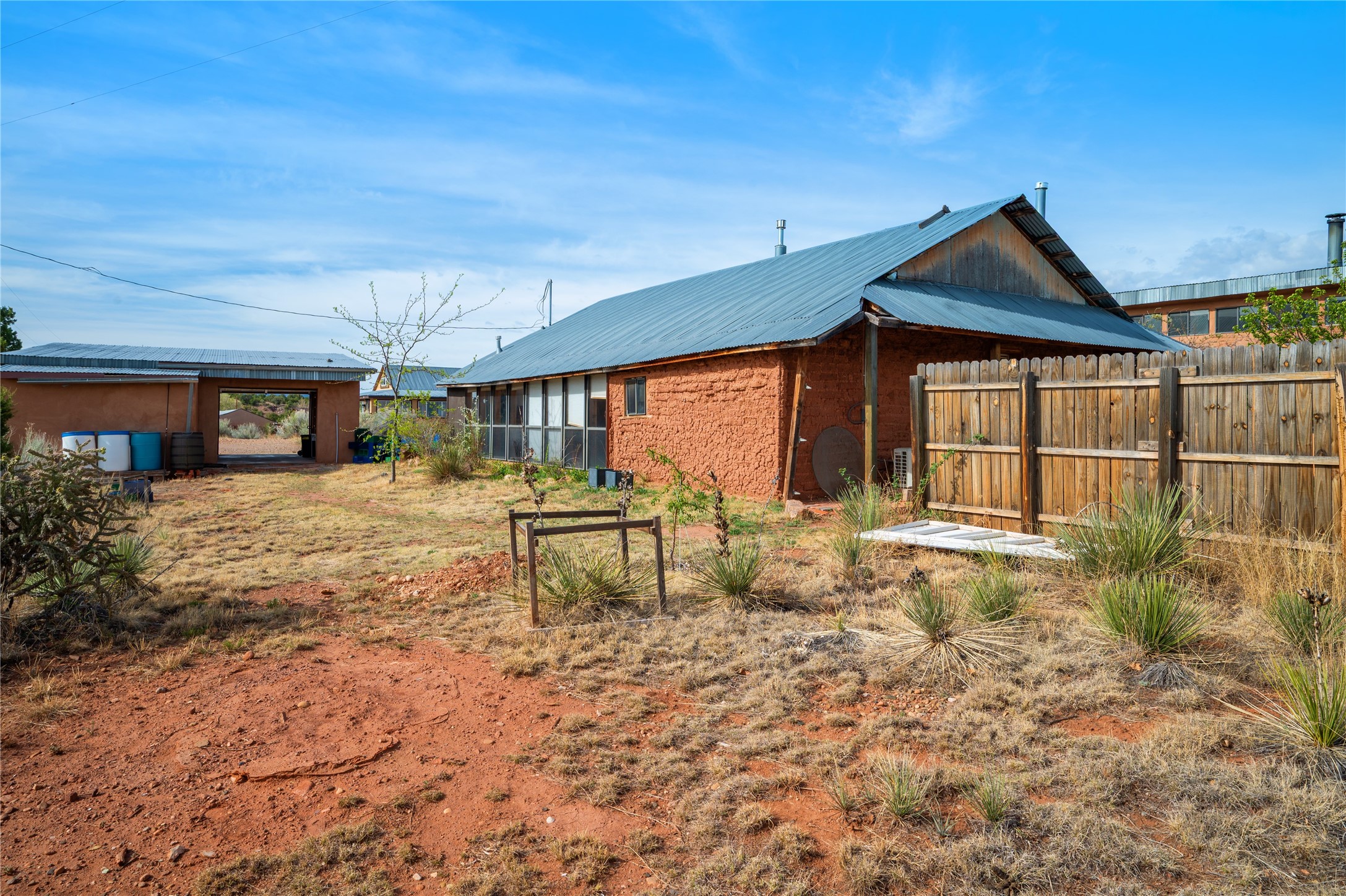 3-4 County Rd B41C San Jose, NM 87565 - Photo 25 of 41 Side yard, back of garage and sunroom side of the adobe home.
