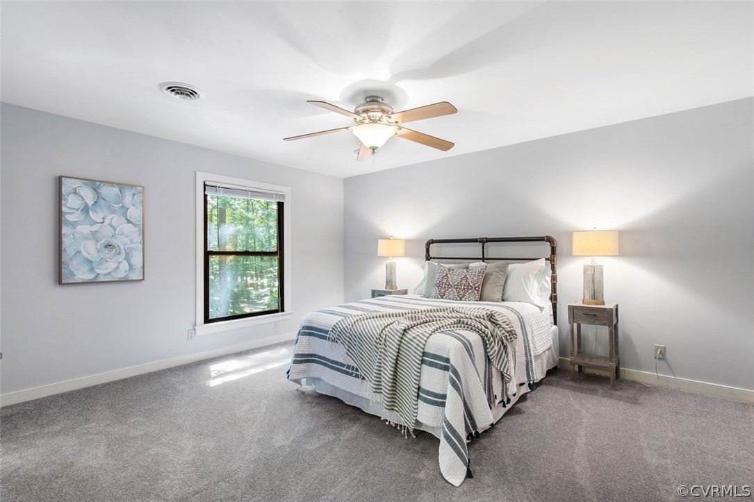 4000 Poplar Grove Road Midlothian, VA 23112 - Photo 25 of 42 a spacious bedroom with a bed and a chandelier