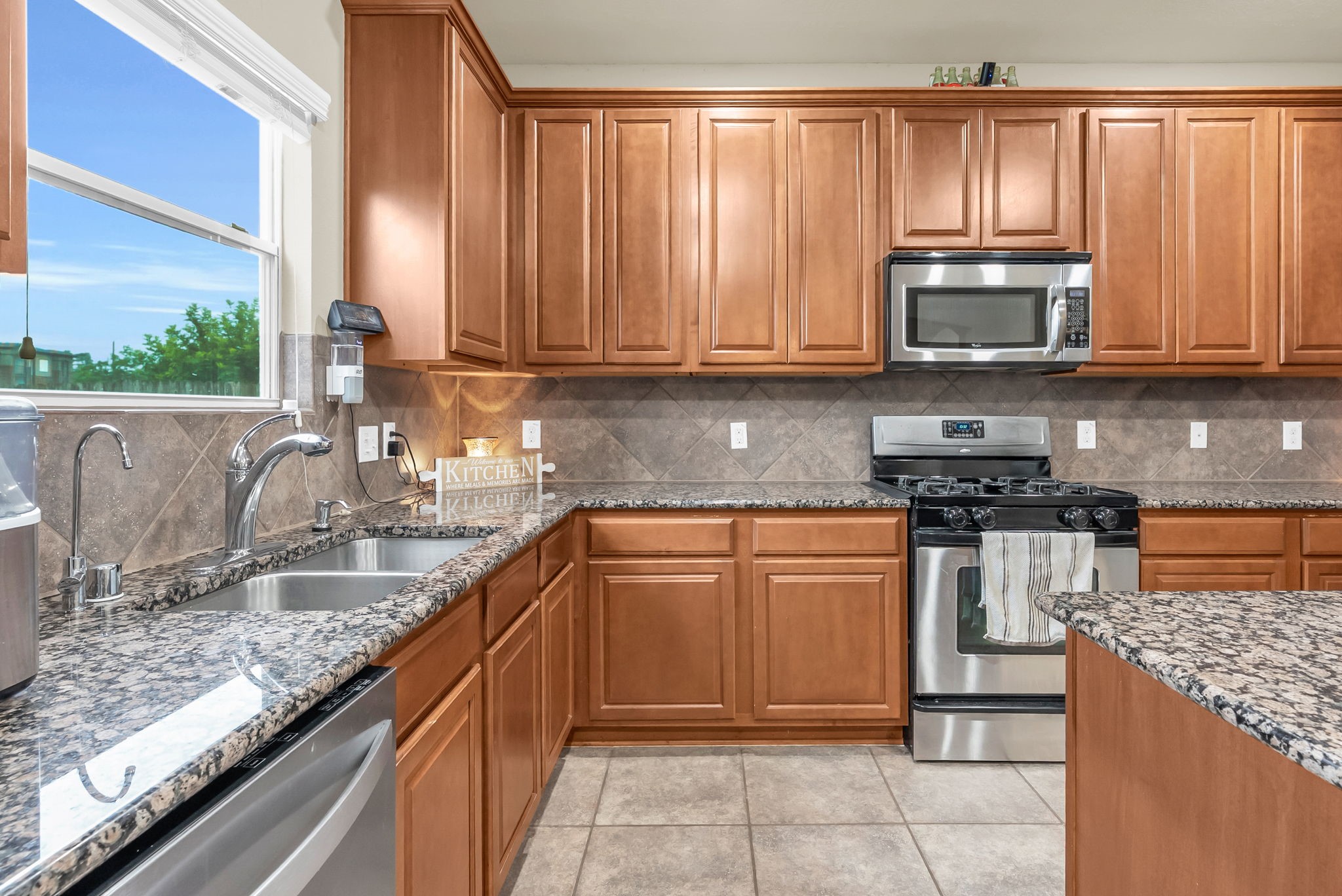 16619 Dover Mills Drive Spring, TX 77379 - Photo 18 of 49 a kitchen with granite countertop a stove top oven sink and cabinets