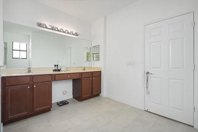 a spacious bathroom with a double vanity sink and a mirror