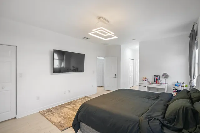 a bedroom with a bed and a tv