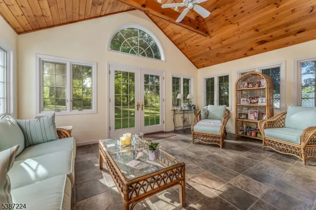 a living room with furniture and floor to ceiling windows