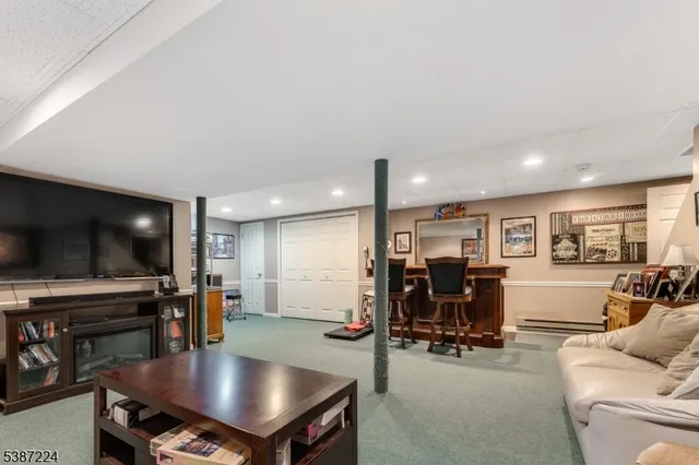 a view of a livingroom with furniture and a flat screen tv