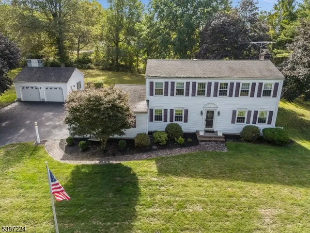 a house that has a big yard with plants and trees