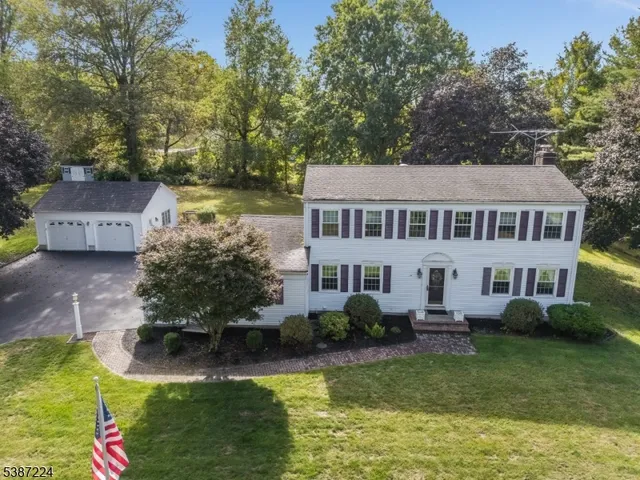 a aerial view of a house with swimming pool and a yard