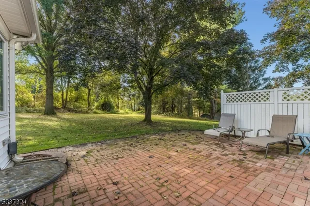 a view of backyard with tree and outdoor seating