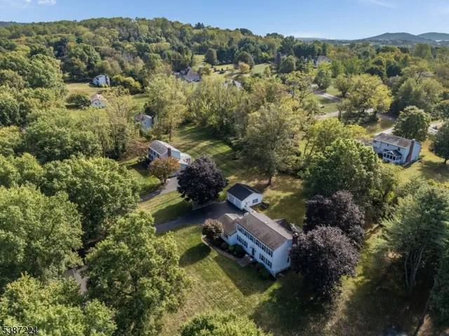 an aerial view of residential house with yard and outdoor seating