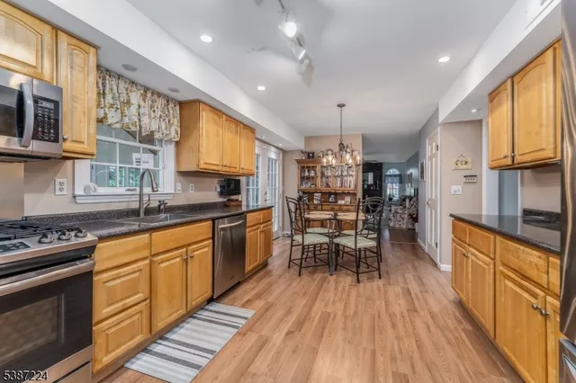 a kitchen with granite countertop lots of counter top space and stainless steel appliances