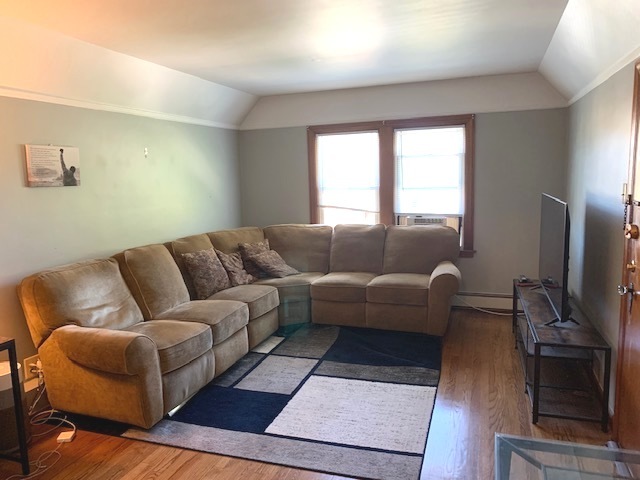 10931 South Artesian Avenue, Unit 2F Chicago, IL 60655 - Photo 3 of 11 a living room with furniture and a flat screen tv