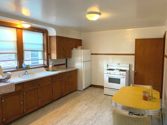 10931 South Artesian Avenue, Unit 2F Chicago, IL 60655 - Photo 6 of 11 a kitchen with a sink appliances and cabinets