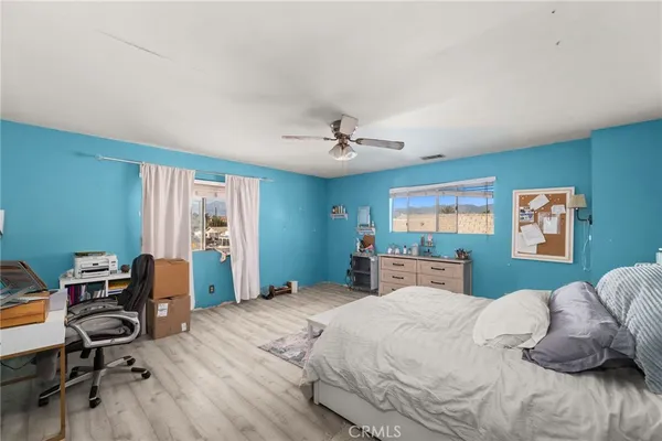 a bedroom with furniture and a chandelier