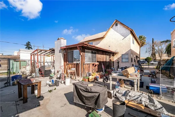 a view of a back yard of the house and car parked