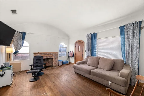 a living room with furniture gym equipment and a flat screen tv