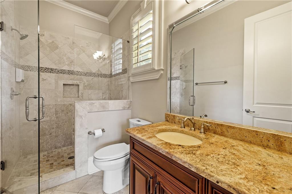 2267 Echo Trail Northeast Atlanta, GA 30345 - Photo 26 of 78 a bathroom with a granite countertop sink toilet and shower