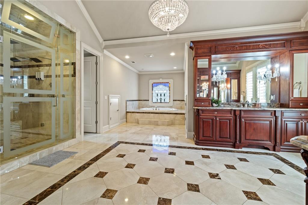 2267 Echo Trail Northeast Atlanta, GA 30345 - Photo 35 of 78 a bathroom with a sink a large mirror and a shower