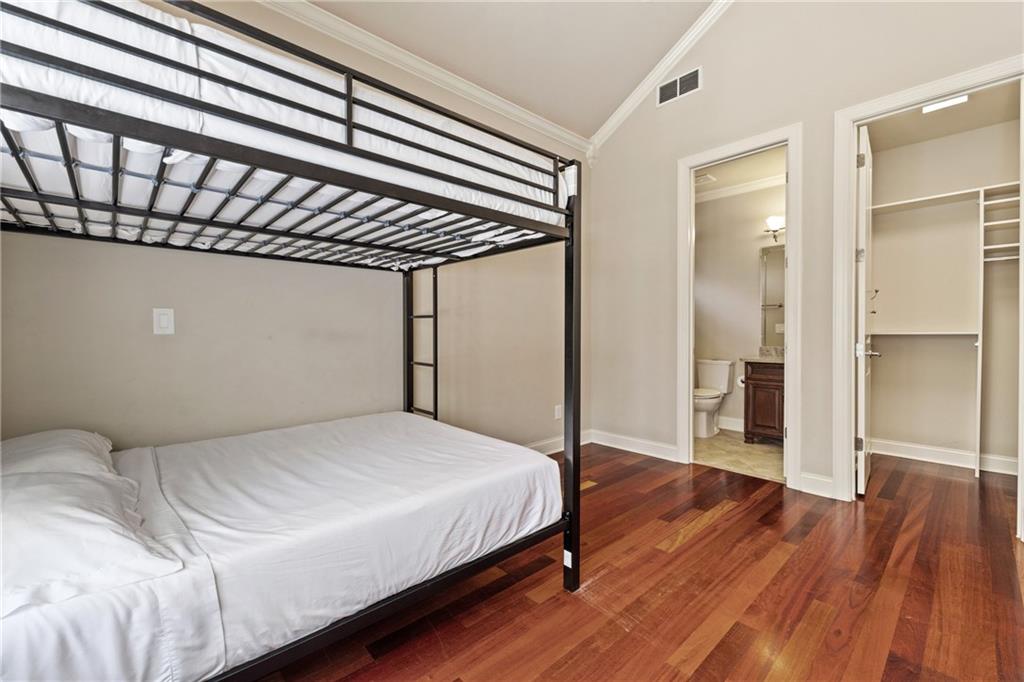 2267 Echo Trail Northeast Atlanta, GA 30345 - Photo 47 of 78 a bedroom with a bed and wooden floor