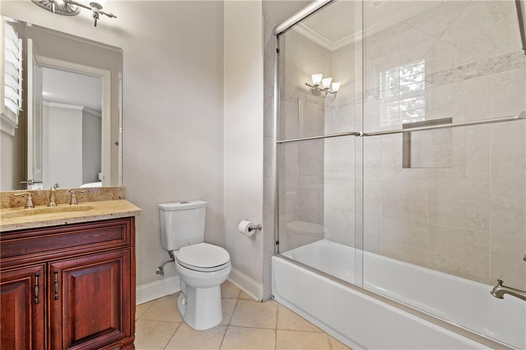 2267 Echo Trail Northeast Atlanta, GA 30345 - Photo 61 of 78 a bathroom with a granite countertop sink a toilet and shower