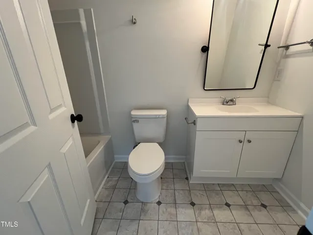 a bathroom with a sink toilet and vanity