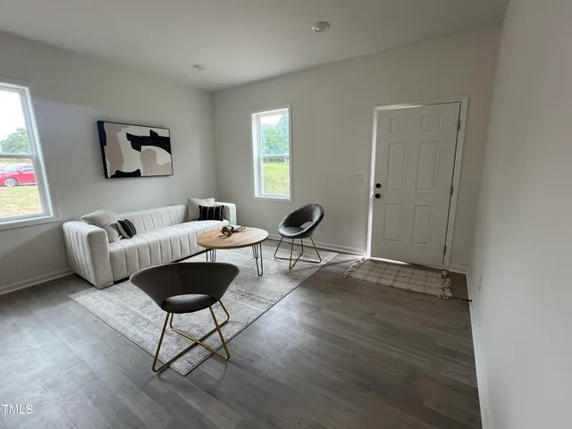 a living room with furniture and a window