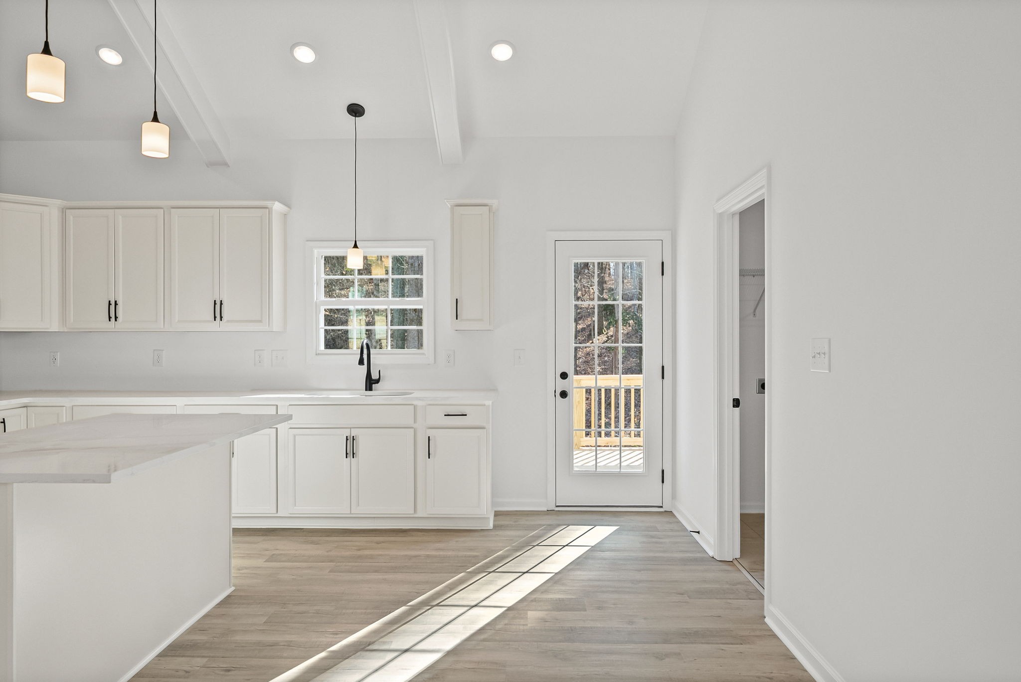 612 Hill Road Clarksville, TN 37040 - Photo 11 of 44 a large white kitchen with granite countertop a sink and dishwasher with wooden floor