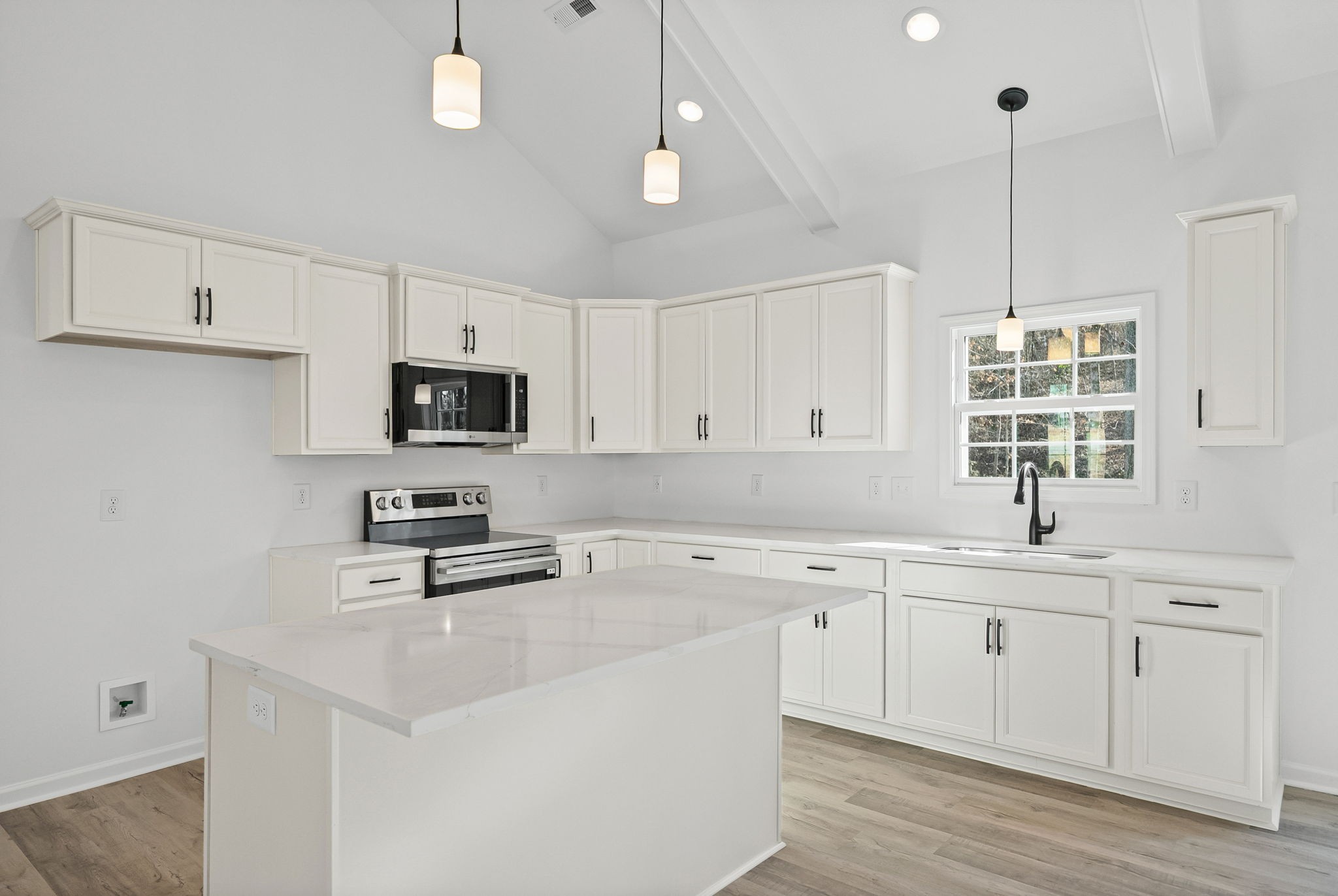 612 Hill Road Clarksville, TN 37040 - Photo 12 of 44 a kitchen with stainless steel appliances a sink a stove a microwave a center island and cabinets
