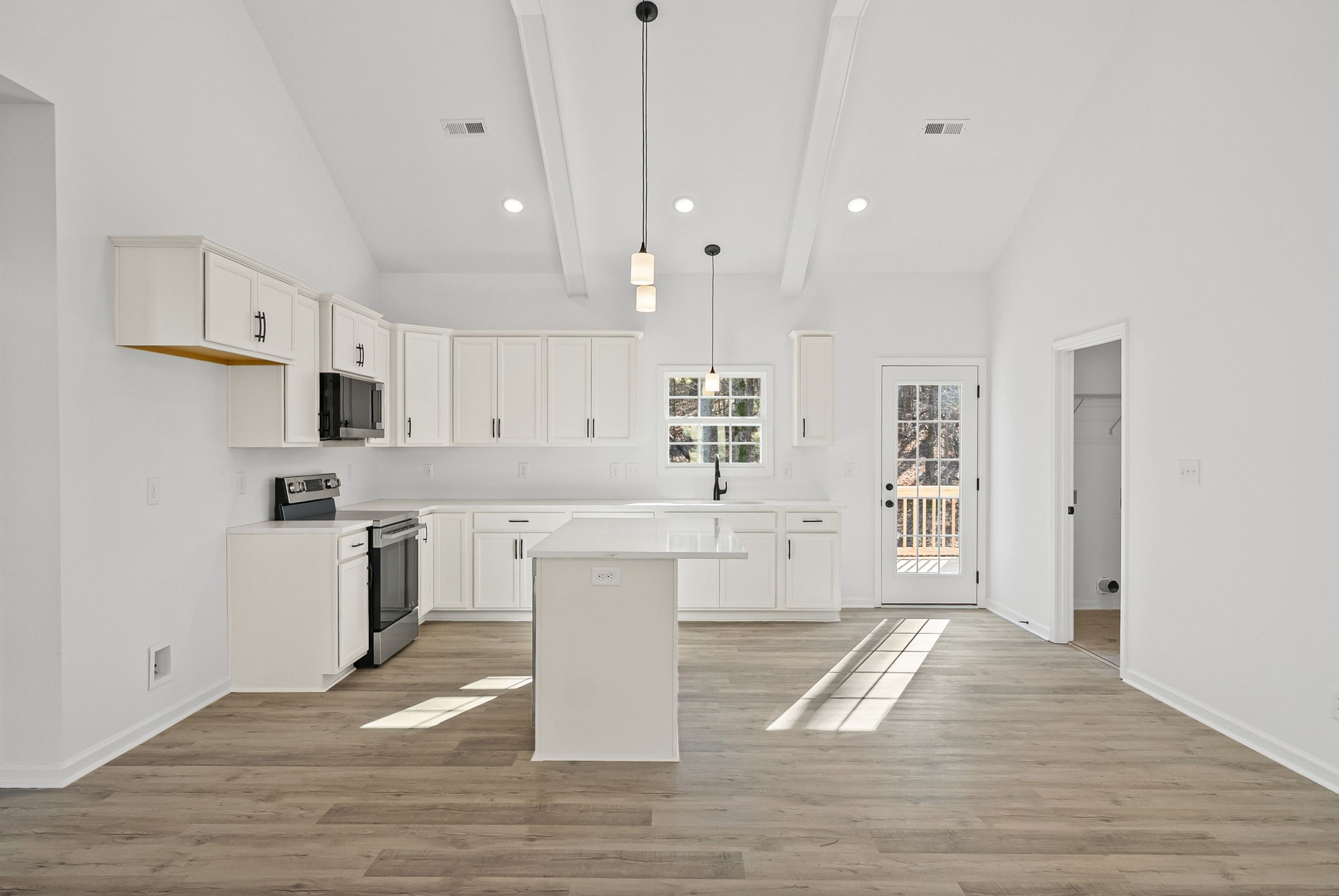 612 Hill Road Clarksville, TN 37040 - Photo 10 of 44 a large white kitchen with cabinets and wooden floor