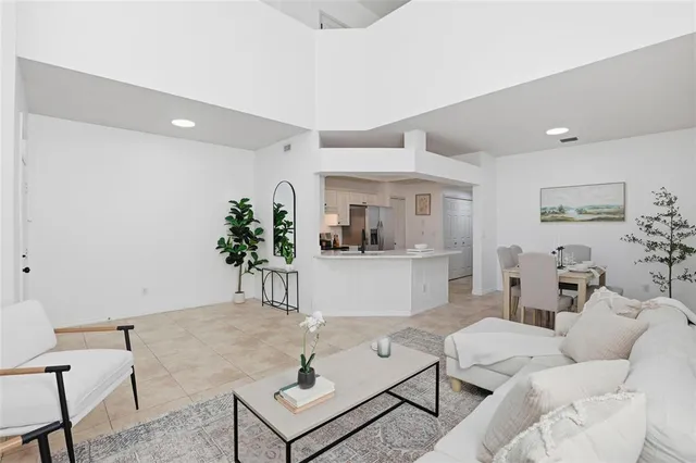 a living room with furniture and a potted plant
