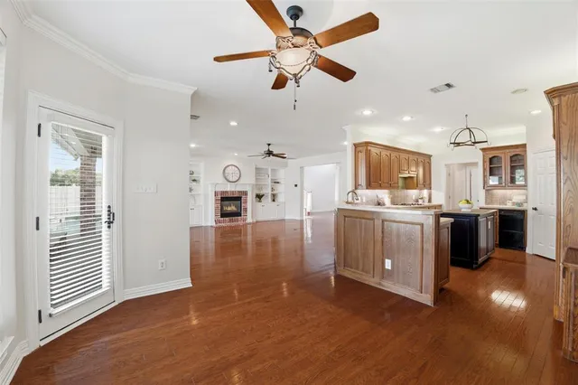 a view of a kitchen with a sink stainless steel appliances and cabinets