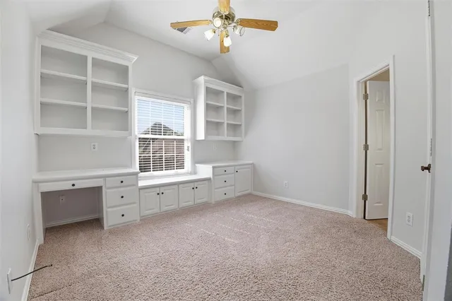a room with a white cabinets and window