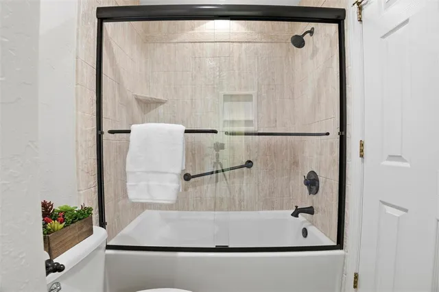 two white bath tub sitting next to a white door