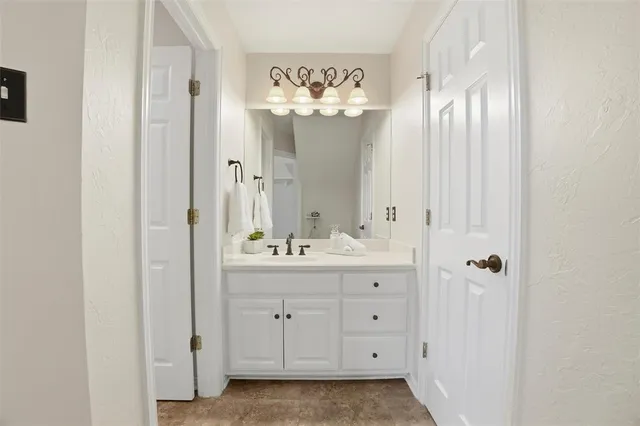 a bathroom with a sink mirror and a shower