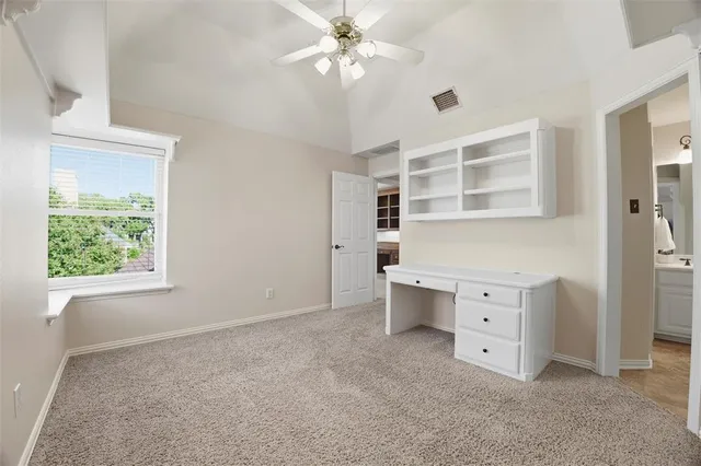 a room with a desk and a window