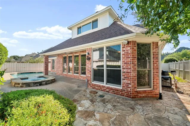 a backyard of a house with barbeque oven and outdoor seating