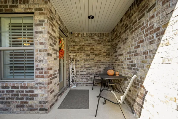 a lamp is sitting on a brick wall