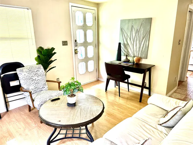 a living room with furniture and a potted plant